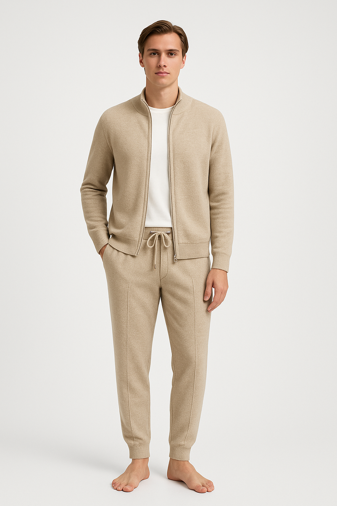 Man wearing a beige tracksuit on a white background