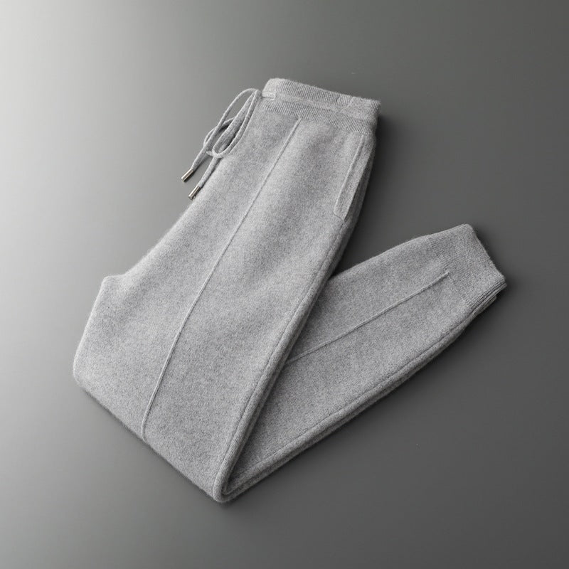 Folded gray sweatpants on a gradient gray background