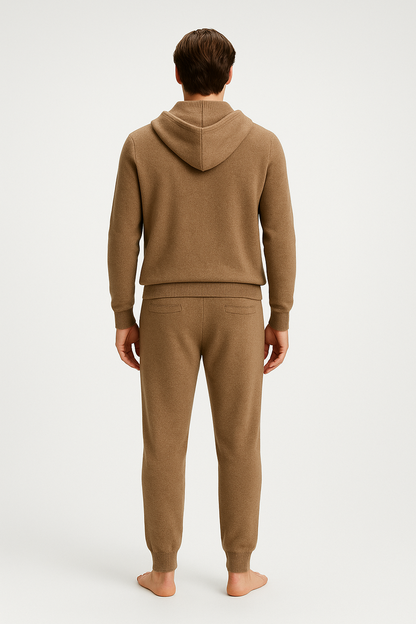 Person wearing a beige hoodie and pants on a white background