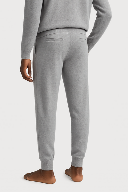 Gray sweatpants worn by a person on a white background