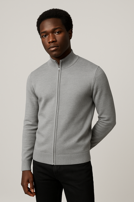 Man wearing a gray zip-up sweater against a plain background