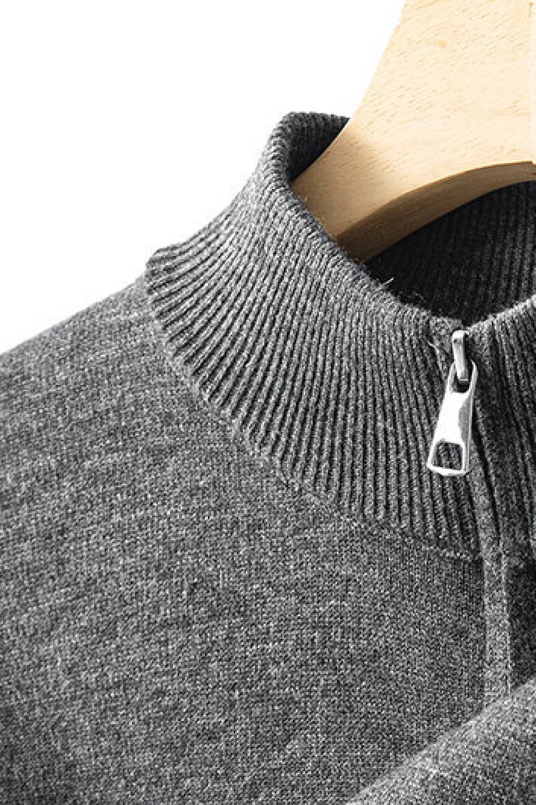 Close-up of a gray sweater with a zipper on a mannequin.