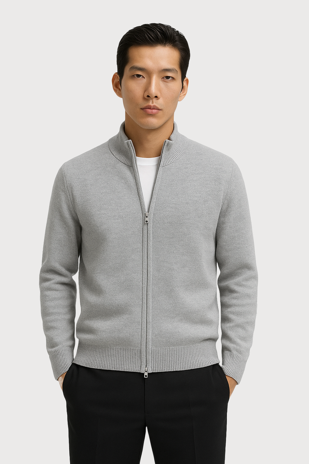 Man wearing a gray full zip-up cardigan over a white shirt on a light gray background