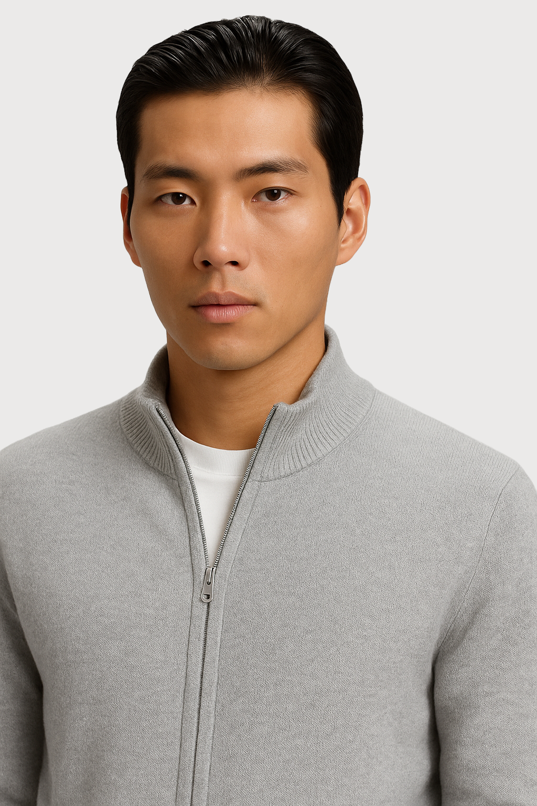 Man wearing a gray full zip-up cardigan over a white shirt on a light gray background