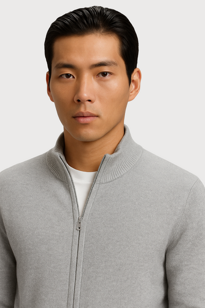 Man wearing a gray full zip-up cardigan over a white shirt on a light gray background