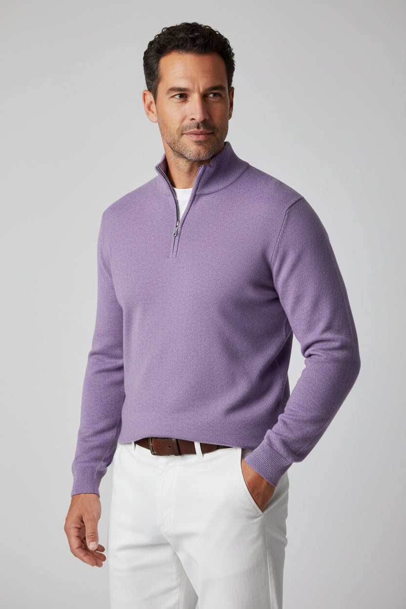 A man wearing a light purple long-sleeve quarter-zip knit sweater over a white undershirt and blue jeans.