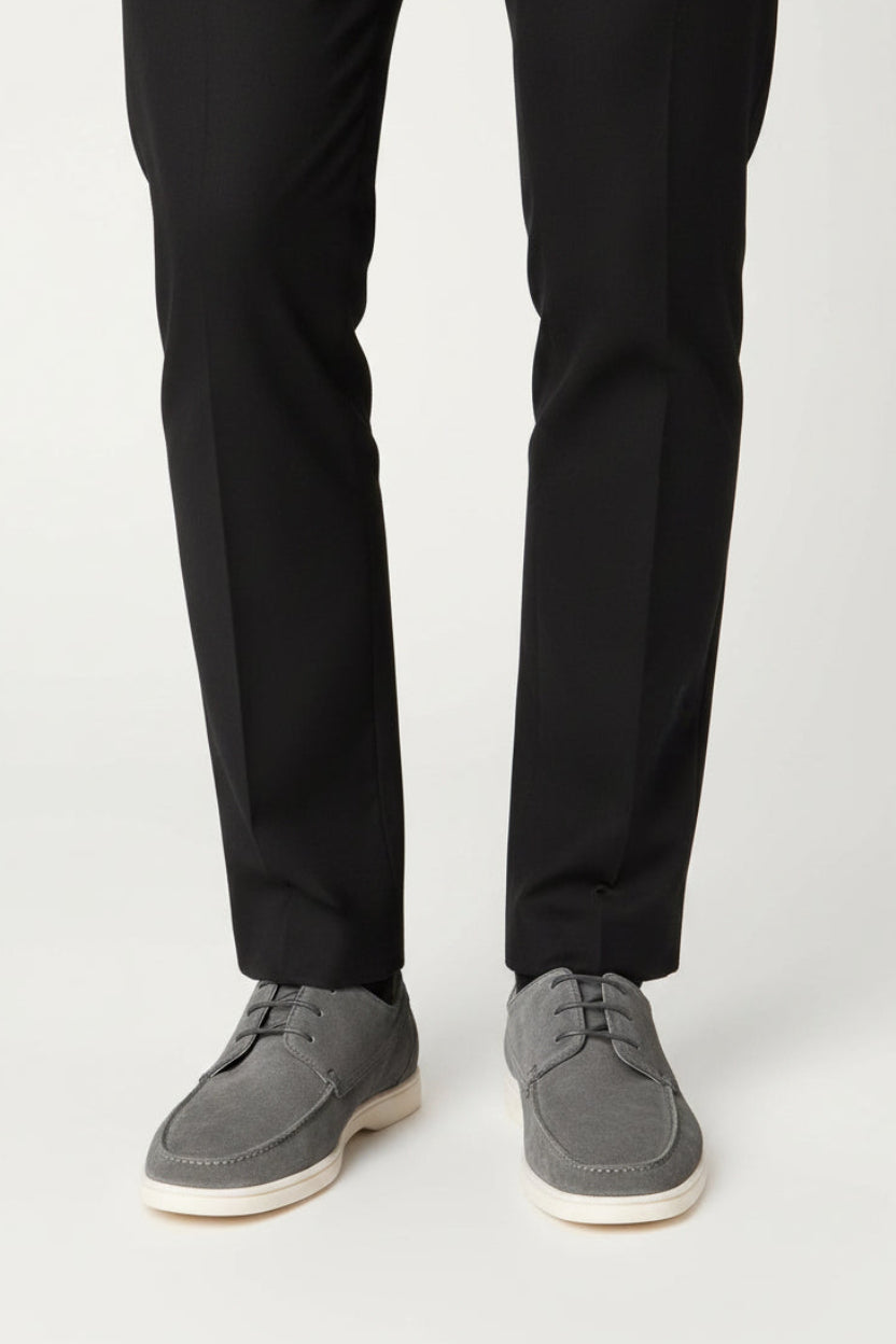 Pair of gray suede shoes on a white background