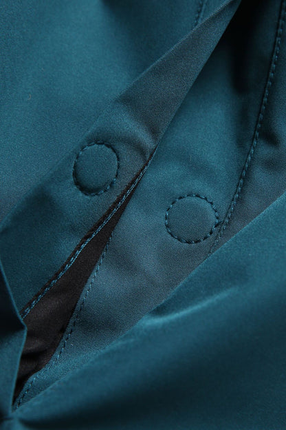 Close-up of a teal jacket with buttons and stitching details